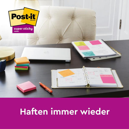 On a desk are a planner, laptop, and colorful Post-it® Super Sticky Z-Notes (76x76 mm) from 3M Deutschland GmbH. The stacks show the 14+2 free pack (90 sheets/block, PEFC certified). Text: "Stick again and again. 14 pads + 2 free.