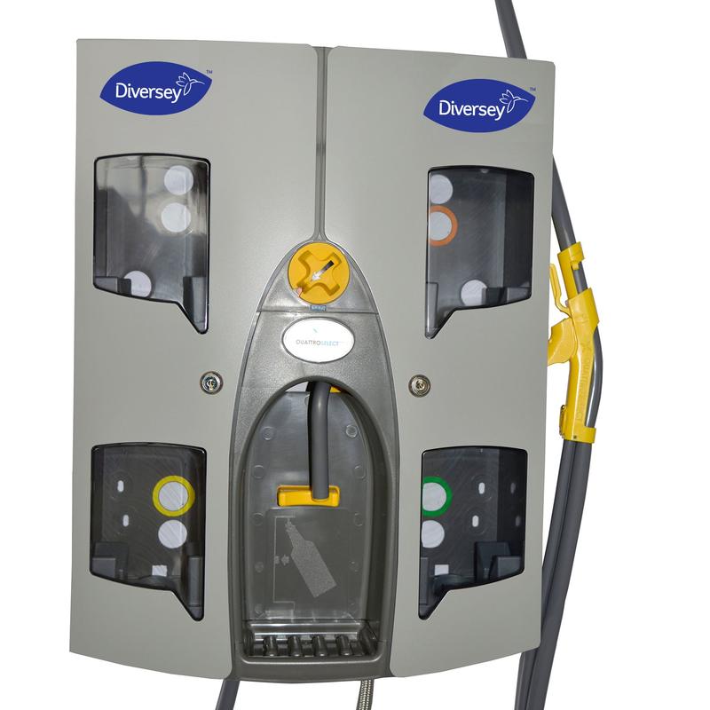 The Quattro Select Uni AirGap dispensing station from Diversey Deutschland GmbH & Co. OHG is a gray wall-mounted device for up to 4 products, with four visible compartments, transparent panels, attached hoses, compact design, rotary knob, and lever.