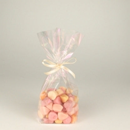 A Starpak 10 bottom bag, a transparent PP bag filled with pink and beige sweets and tied with a light ribbon, is centered against a simple light background.