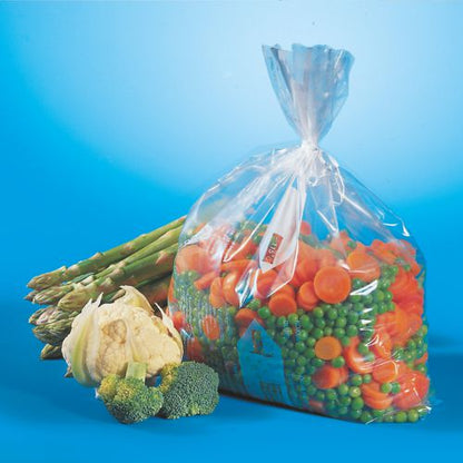 A transparent Starpak 45 freezer bag (LLDPE, 6 l, 46 x 30 cm), filled with sliced carrots and green peas, is presented next to fresh asparagus, cauliflower, and broccoli - ideal for freezer storage. Folding box (45 pieces).