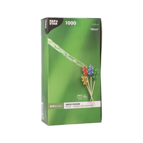 Der PAPSTAR 1000 Deko-Picker 6,8 cm „Rüschen“ der PAPSTAR GmbH wird in einer grünen Box mit bunten Rüschenspießen zur Tischdekoration geliefert und verfügt über eine Verpackung, auf der die Spieße und ein Tautropfen auf Gras in Nahaufnahme abgebildet sind.