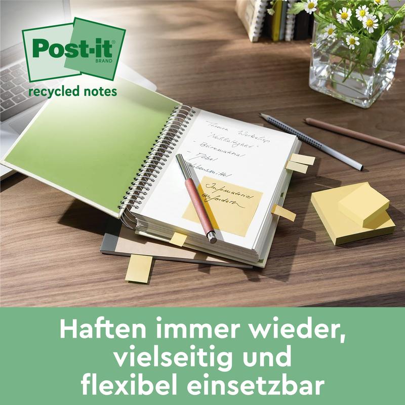 A desk shows an open notebook with a Post-it® Recycling Note, pens, and stacks of 76mm x 127mm PEFC-certified Post-it® Recycling Notes (100 sheets/block) from 3M Deutschland GmbH. In the background, a vase with green stems is visible. The German text promotes the recycling of notes.