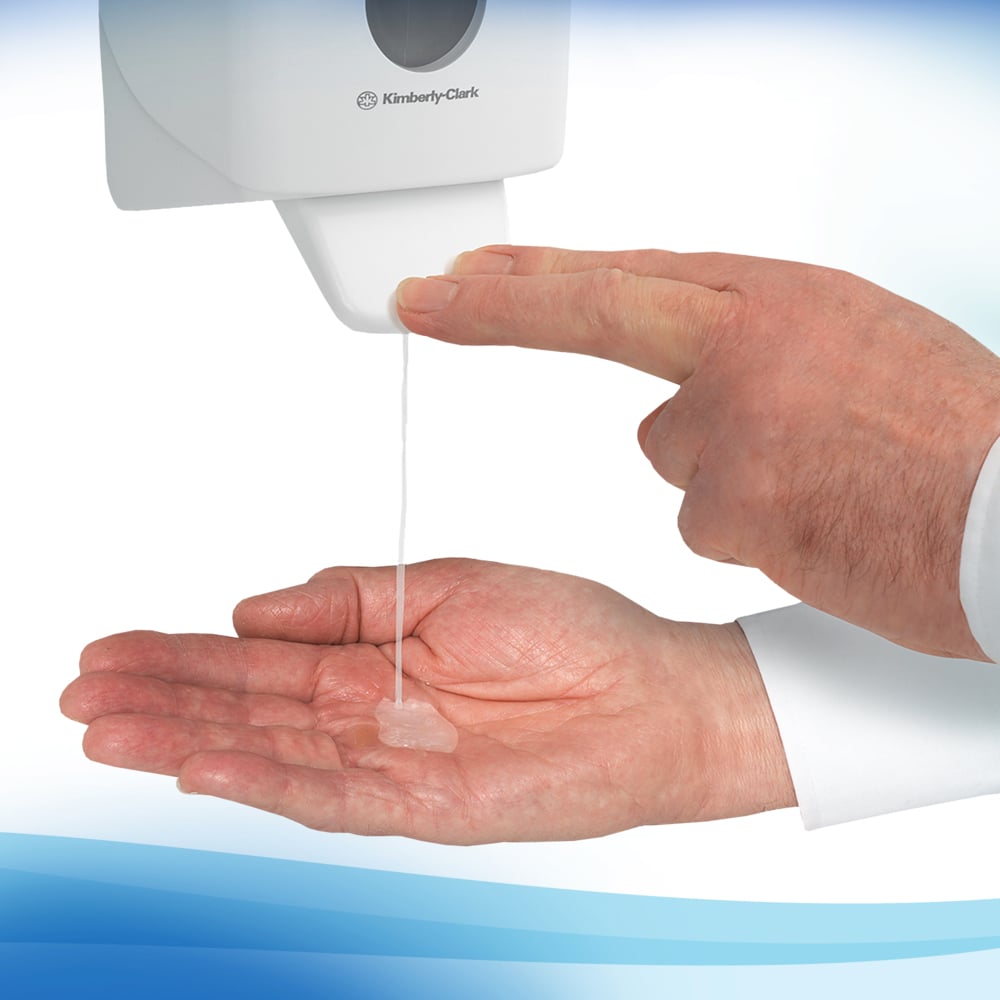A person dispenses the transparent Scott® Control™ Antibacterial Hand Cleanser (1 Ltr cassette) from Kimberly-Clark GmbH onto their palm from a wall-mounted dispenser for hygienic hand cleaning.