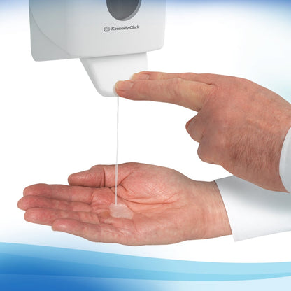 A person dispenses the transparent Scott® Control™ Antibacterial Hand Cleanser (1 Ltr cassette) from Kimberly-Clark GmbH onto their palm from a wall-mounted dispenser for hygienic hand cleaning.