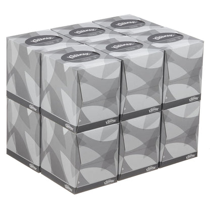 A stack of nine Kleenex® facial tissues - cube box / white from Kimberly-Clark GmbH, arranged in three rows and columns with a gray geometric design, is ideal for facial care.