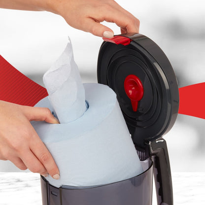 A user inserts a large blue roll into the open WypAll® Reach™ Centrefeed Dispenser (Black) from Kimberly-Clark GmbH, showing the red release mechanism - perfect for professional use.