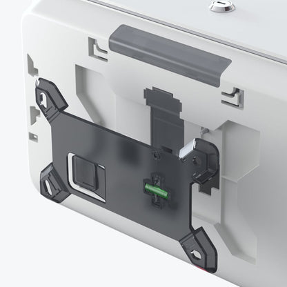 Close-up of the back of a Kimberly-Clark Professional™ Icon™ toilet paper dispenser - small rolls from Kimberly-Clark GmbH, showing the black bracket and visible internal components including a green plug.