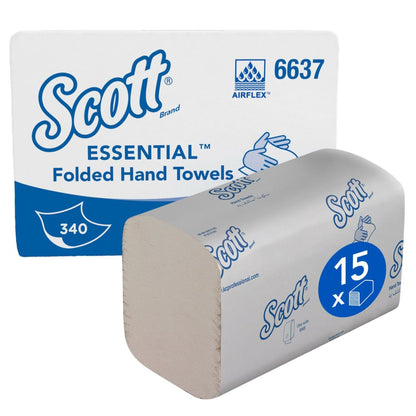 A carton of Scott® Essential™ Interfold Hand Towels (white, small) from Kimberly-Clark GmbH contains 15 packs, each with 340 sheets, stacked for hygienic hand drying alongside the box labeled with the Scott logo.