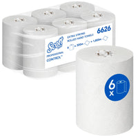Six white rolls of Scott® CONTROL EXTRA STRONG paper towels from Kimberly-Clark GmbH are packaged together in a clear sleeve, with the front roll marked with a blue "6x" symbol. These extra-strong paper towels are supplied in boxes of 6 rolls for professional use.