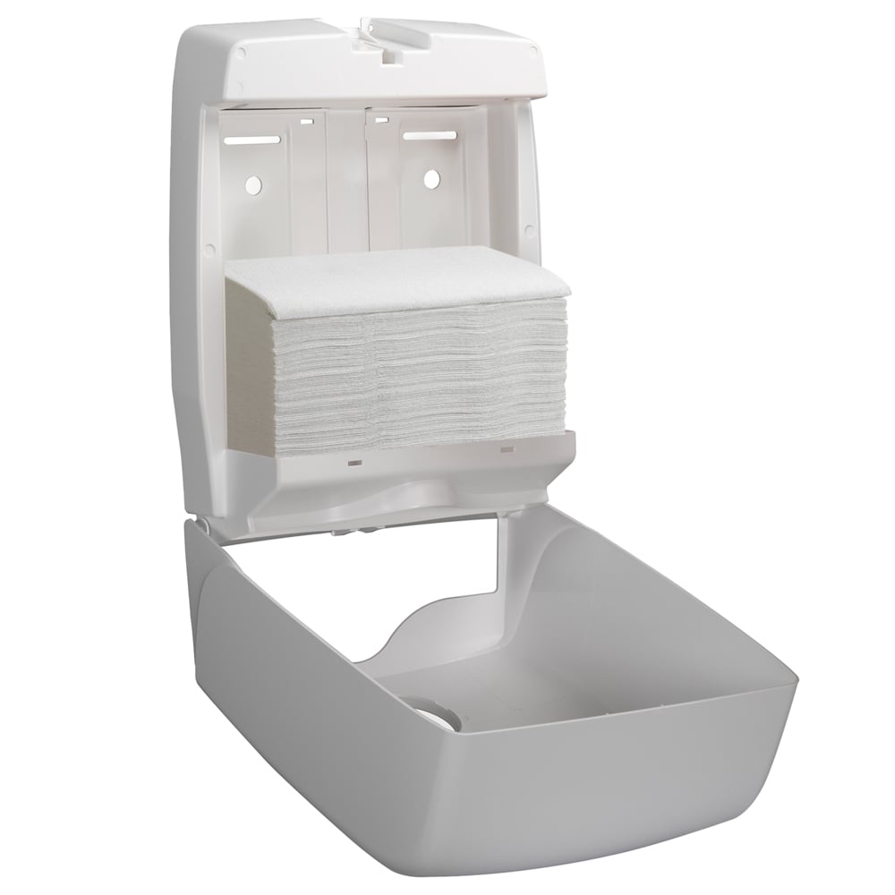 A white wall dispenser is open, showing inside Scott® Control™ towels, folded/White/Large (15 clips x 240 sheets) from Kimberly-Clark GmbH. The simple design of the dispenser stands out against a plain background.