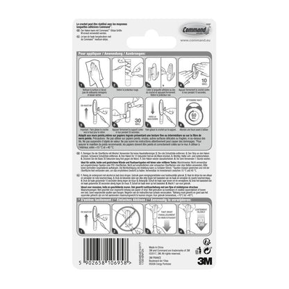 The back of the 3M Deutschland GmbH Command™ Medium Designer Hook in metal look, 17081BN packaging shows a pictorial, multilingual guide for attaching and removing the strong hook, as well as a barcode at the bottom.