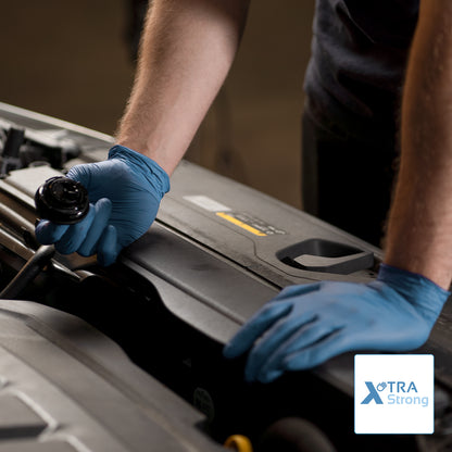 A person wearing ARNOMED NITRIL BLUE XTRA STRONG disposable gloves from ARNOWA GmbH opens a car hood. Only the upper body and arms are visible; the Xtra Strong logo is shown in the lower right corner.