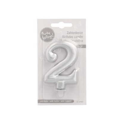 The PAPSTAR GmbH number candle with holder, 7 cm, silver, comes in clear plastic packaging with a white cardboard back and multilingual text. A small holder is attached to the candle base.