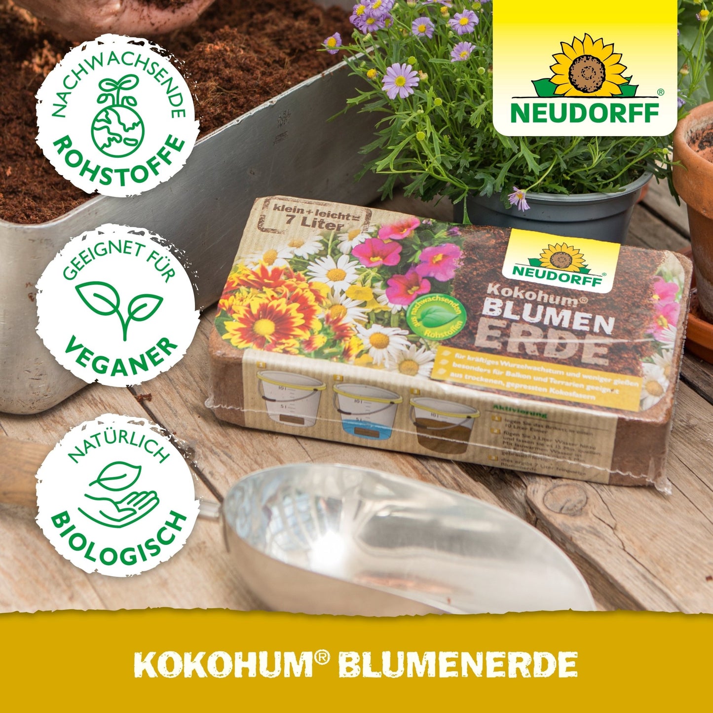 A package of Neudorff Shop Kokohum Flower Soil lies on a table with soil, a metal shovel, flower pots, and plants. The symbols indicate that the product is vegan, organic, and made from renewable materials.