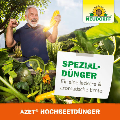 An older man with gray hair and a beard celebrates in a lush raised bed garden and holds a yellow zucchini in his hand. A sign reads "Special fertilizer for a delicious & aromatic harvest". Neudorff Shop Azet Raised Bed Fertilizer liquid logo top right.