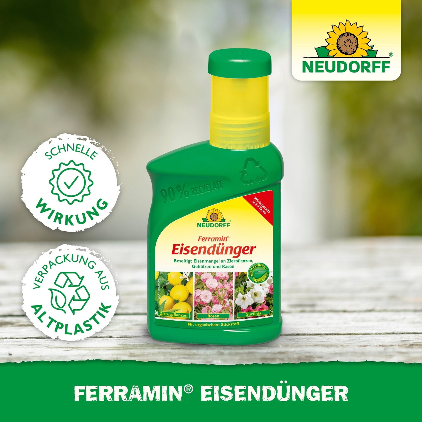 A green plastic bottle with Ferramin iron fertilizer from Neudorff Shop stands on a wooden surface. The label features flowers and lemons, advertising quick action against nitrogen deficiency and noting that it is packaged in recycled plastic.