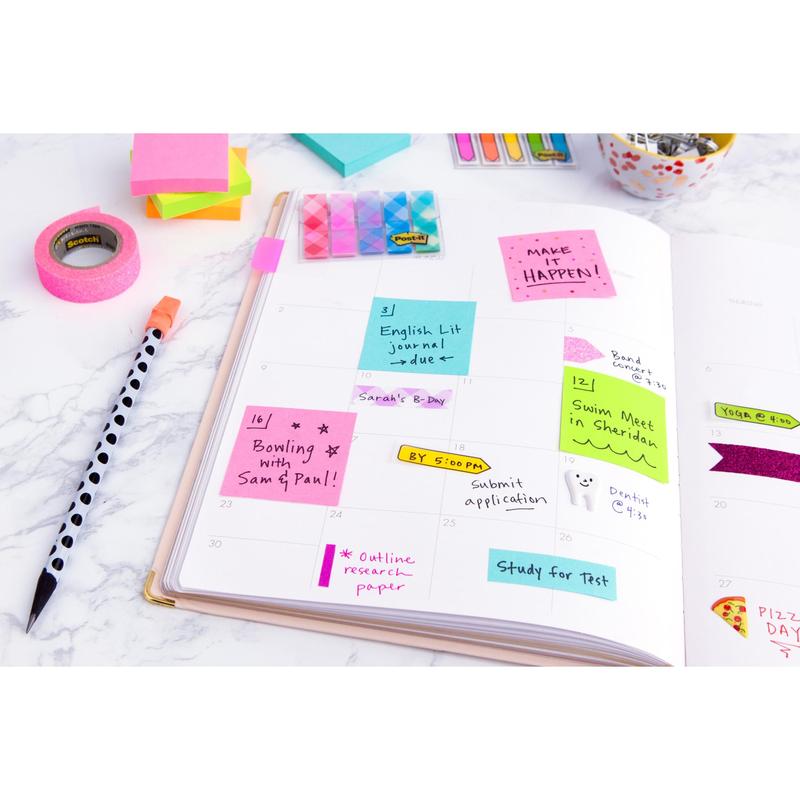 On a white desk lies an open planner with handwritten notes, a striped pen, office supplies, and colorful Post-it® notes (76 mm x 127 mm, 100 sheets/block, 100% PEFC) from 3M Deutschland GmbH for marking tasks and appointments.