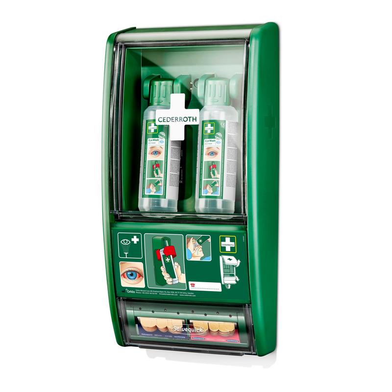 A green Cederroth eye wash station from Orkla Wound Care AB is wall-mounted, holds 2x500 ml bottles (725200) and a Salvequick plaster dispenser (490700). Illustrated instructions on the front and a bottom compartment assist in eye wash emergency situations.