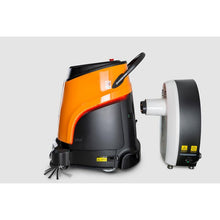 An orange-black TASKI Ecobot 40/50P is parked next to a tall, white Diversey TASKI GS Charging Station 40/50 (charging station for the TASKI Ecobot 40/50P, 1 piece) against a plain light gray background.