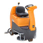 The TASKI swingo 2500 from Diversey Germany is a compact, economical ride-on scrubber-dryer with a gray-orange housing, steering wheel, black seat, visible brushes, lithium technology, and speed-dependent dosing.