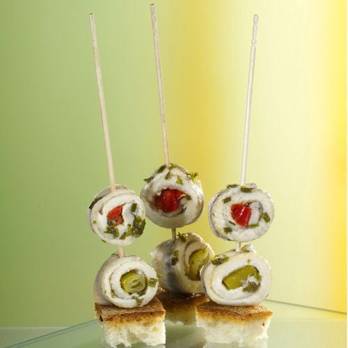 Drei gerollte Fischfilet-Spieße stehen aufrecht auf Brotwürfeln, präsentiert als PAPSTAR Fingerfood-Picker "pure" 15 cm (gedrechselt, elegant) von PAPSTAR GmbH - ideal für stilvolle Catering-Events.