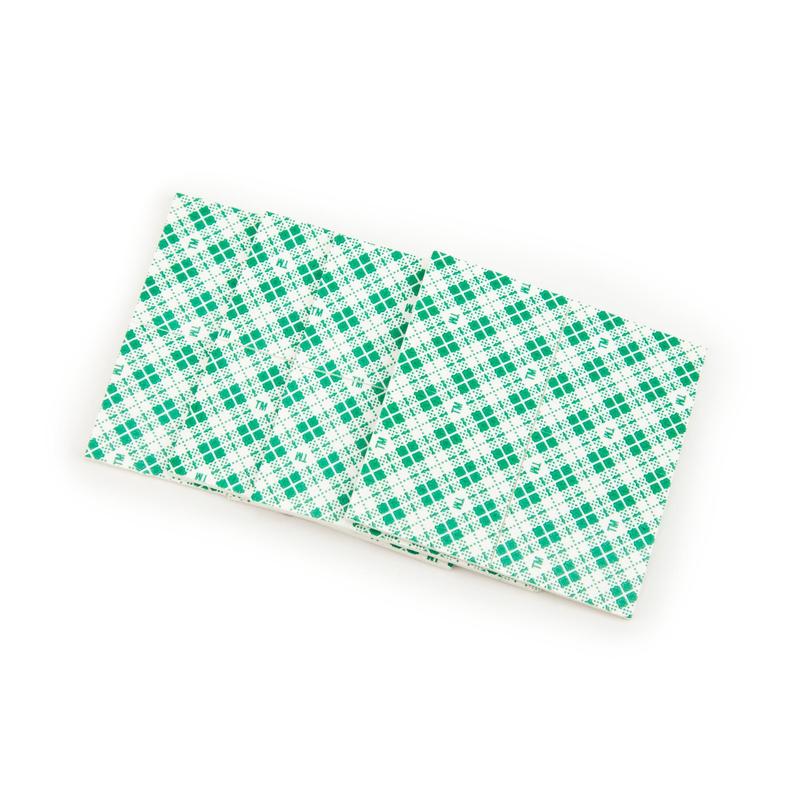 A pair of Scotch-FIX™ Double-Sided Indoor Mounting Squares 4496-ST16-P (25 mm x 25 mm, 16 pieces/package) from 3M Germany GmbH with a green checkered pattern offer strong adhesive power for secure indoor attachment.
