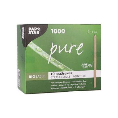 A green-and-white box from the PAPSTAR The GmbH box labeled "pure" contains 1,000 eco-friendly, sturdy wooden stir sticks (11 cm). The folding box features product information in several languages as well as a vertical image of a stir stick.