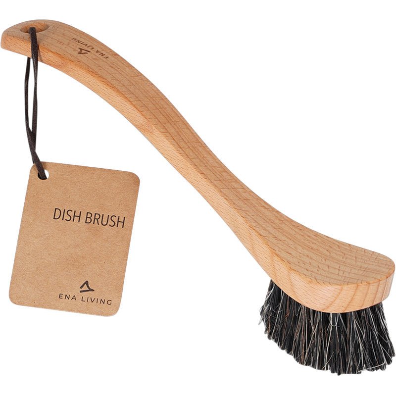 Die ENA Living Spülbürste mit weichen Borsten der Abena Re-Seller GmbH wird mit Holzgriff, dunklen Borsten und braunem Anhänger "Dish Brush" geliefert - ideal für eine sanfte Geschirrreinigung. Erhältlich im Karton (12 Packungen).