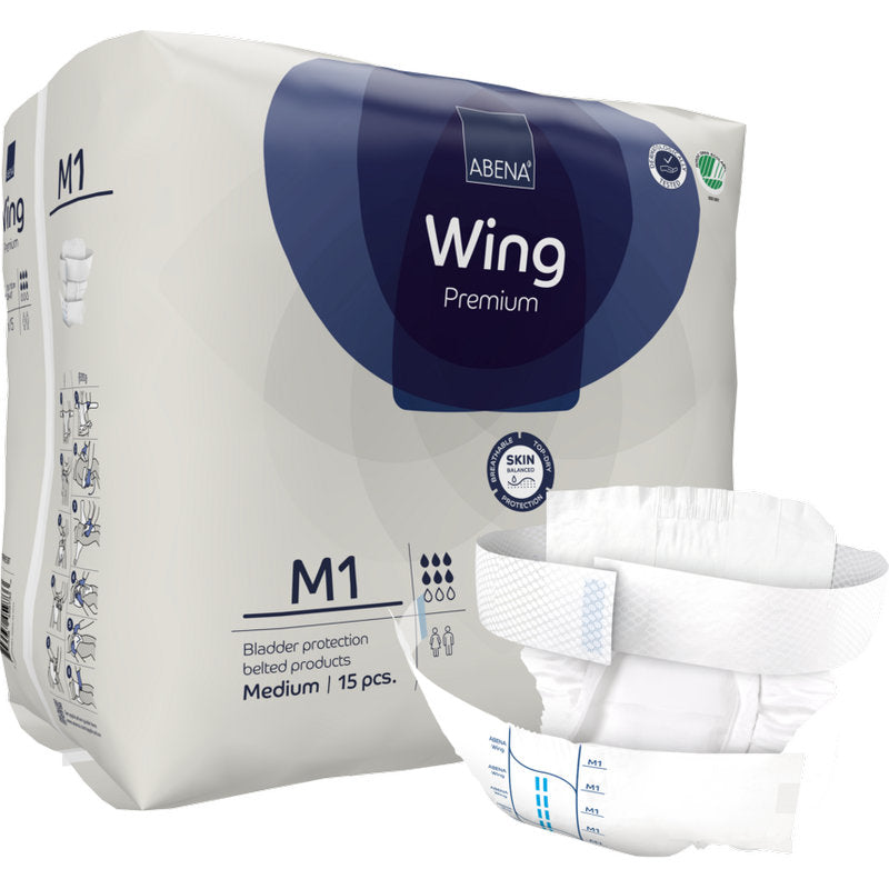Eine Packung Abena Re-Seller GmbH ABENA Wing Premium ist mit einem ausgeklappten Pad vorne abgebildet, das Schutz und Komfort bietet. Auf der Verpackung steht, dass sie 15 mittelgroße Pads zum Schutz der Blase enthält.