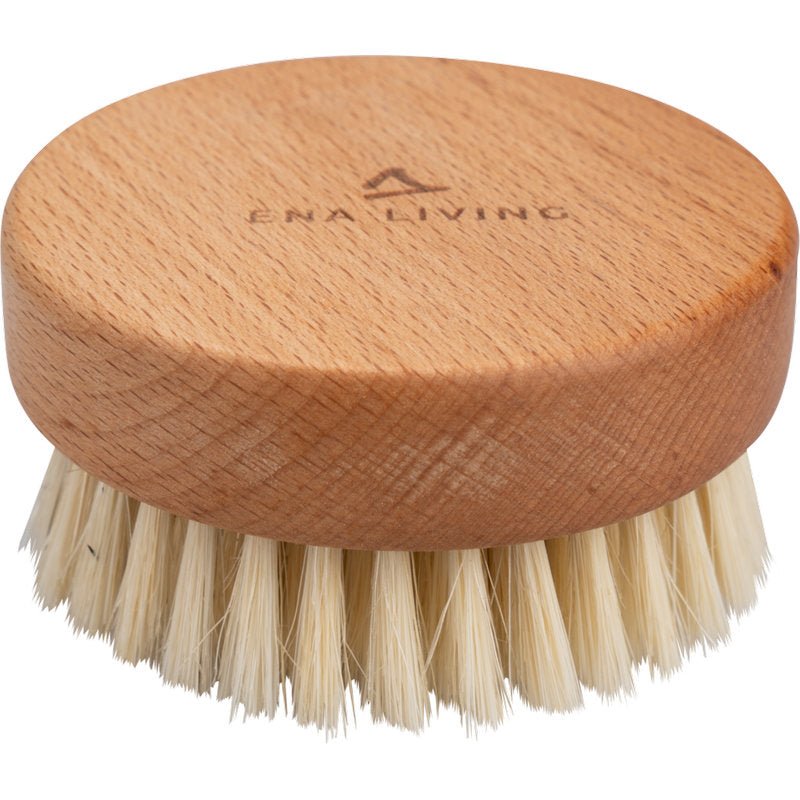 The ENA Living Hand Massage Brush from Abena Re-Seller GmbH is a round wooden massage brush with natural bristles and the words "ENA LIVING" engraved on the top. Sold in a carton of 24 packs, it is ideal for relaxation and is shown against a white background.