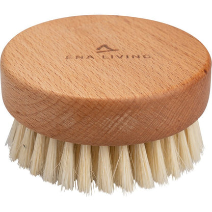 The ENA Living Hand Massage Brush from Abena Re-Seller GmbH is a round wooden massage brush with natural bristles and the words "ENA LIVING" engraved on the top. Sold in a carton of 24 packs, it is ideal for relaxation and is shown against a white background.