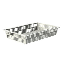 The Novocal ABS basket in gray has a perforated bottom, can be divided using retractable stoppers, and is made of durable ABS material. It is empty and is shown against a white background.