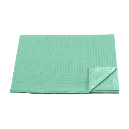 A green absorbent disposable underpad with a quilted structure and a plastic backing, similar to the patient napkins, Tissue/PE, green (box with 500 packs) from AMPri Handelsgesellschaft mbH. The corner of the pad is folded, revealing the backing material. The pad lies on a white background.