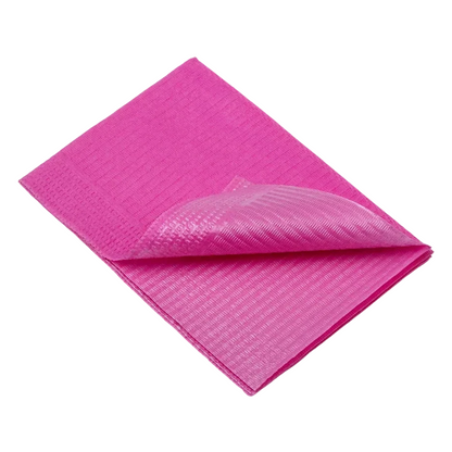 A pink disposable patient napkin from AMPri Dental, resembling a microfiber cleaning cloth, is neatly folded and presented. The texture is clearly visible as one corner is folded up, revealing multiple layers. This patient-friendly napkin from AMPri Handelsgesellschaft mbH lies on a plain white background, showcasing its versatility in dental care.