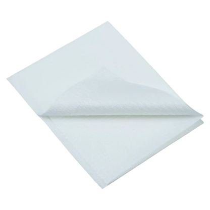 A close-up of a folded white AMPri Dental disposable patient napkin, reminiscent of dental napkins, highlighting its texture and layered appearance. The soft fabric is neatly folded and positioned diagonally against a plain white background.