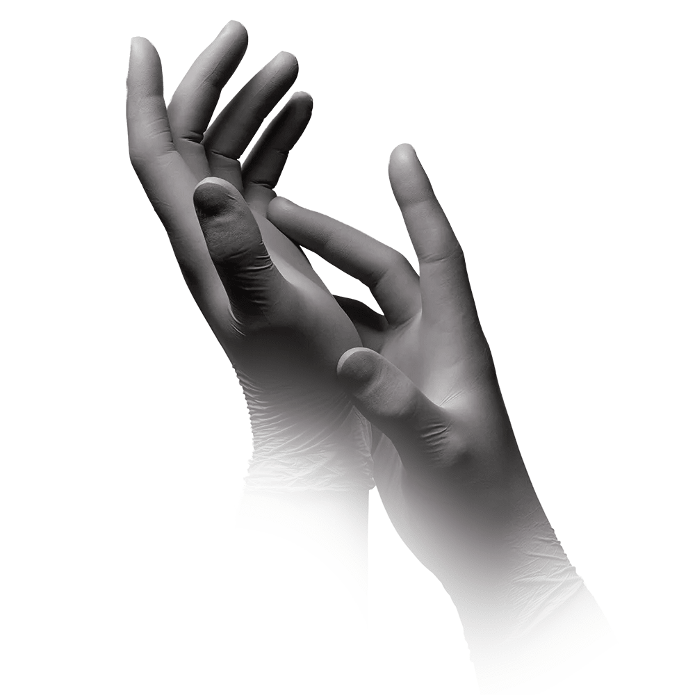 A grayscale image shows two hands wearing MED-COMFORT’s AMPri STYLE PLATINUM powder-free nitrile gloves in silver-gray, manufactured by AMPri Handelsgesellschaft mbH. One hand gently clasped around the other; both are held upward with fingers extended. The background is completely white, and the lower parts of the wrists gradually blend into the silver-gray background.