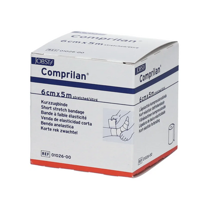 The picture shows a box of BSN Comprilan® elastic bandage, a compression bandage from BSN Medical GmbH, with dimensions of 6 cm x 5 m. The packaging contains multilingual information and an illustration demonstrating the application of the bandage on a leg.