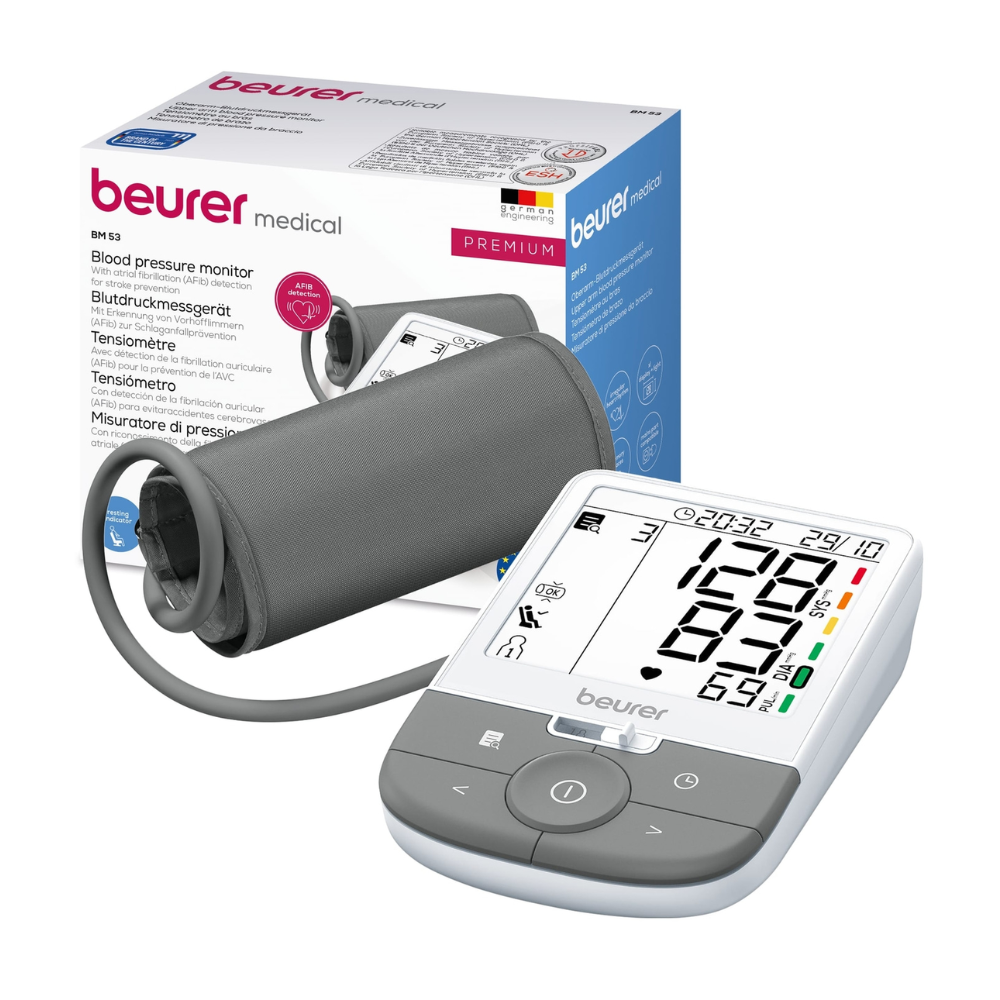 Pictured is a Beurer upper arm blood pressure monitor BM 53 | Package (1 piece) from Beurer GmbH with an LCD screen displaying various readings. The device includes a cuff connected via a tube and is delivered in multilingual packaging. It is described as a premium model and also features arrhythmia detection for identifying irregular heartbeats.