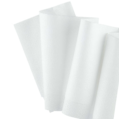 A close-up of three white WypAll® Wettask™ wipes from Kimberly-Clark GmbH, unfolded and slightly overlapping, shows their textured surface - ideal for industrial applications such as oil removal. Box: 6 rolls of 140 sheets each.