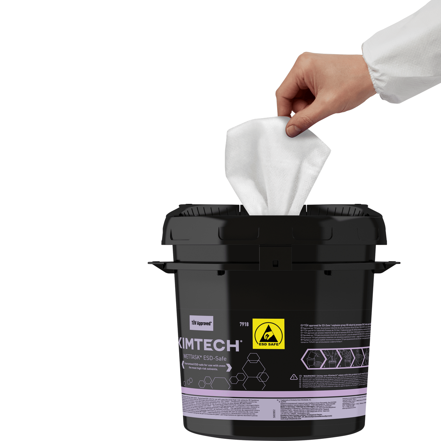 A hand in a white sleeve pulls a wipe from a black Kimtech® WETTASK* ESD roll wiper dispenser from Kimberly-Clark GmbH, which is labeled with an "ESD Safe" sticker, a yellow warning symbol, and white text - ideal for ESD-sensitive areas.
