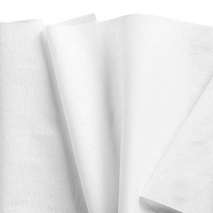 Several WypAll® X80 PowerClean cleaning cloths from Kimberly-Clark GmbH in white are overlapping on a plain background, with their textured surface and sharp edges reminiscent of industrial cleaning. 1 Brag Box x 160 cloths/carton.