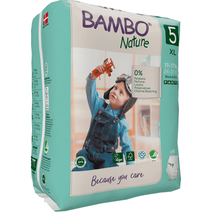 A package of Bambo Nature Pants from Abena Re-Seller GmbH, Size 5 XL (11-17 kg), shows a child in overalls with a toy airplane. The eco-friendly packaging highlights the skin-friendly and environmentally conscious properties.
