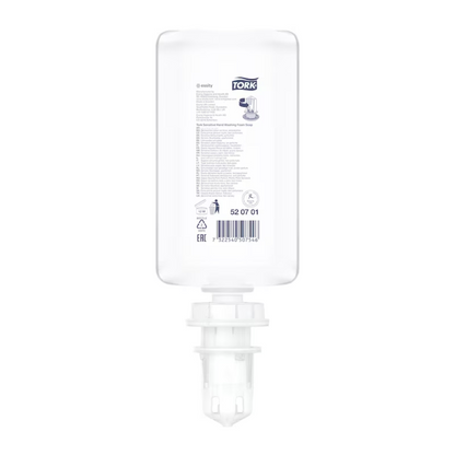 A transparent 1000 ml refill bottle of Tork 520701 Sensitive Hand Foam Soap Premium S4 made of plastic with a white cap and dispenser, depicted upside down. The label bears the TORK logo and indicates ECARF certification and skin compatibility.