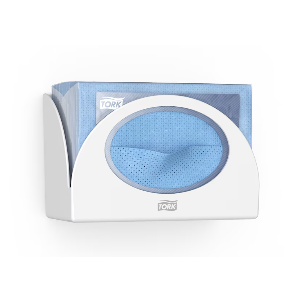 A Tork 655100 Small Pack Paper Dispenser Performance W8 by Tork - Essity Professional Hygiene Germany GmbH, providing hygienic protection, holds a stack of blue disposable towels. One towel is partially pulled through the opening of the dispenser. The 'Tork' logo is clearly visible on both the sleek dispenser and the packaging of the towels.