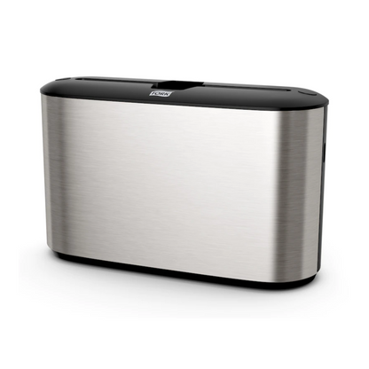 Experience the elegant design of the Tork Xpress® 460005 table dispenser for multifold towels, part of the Image Line H2 collection. This dispenser from TORK – Essity Professional Hygiene Germany GmbH has a sleek, rectangular shape with a black top and a smooth, reflective surface. Its minimalist style seamlessly complements an ultra-modern space and fits perfectly with other Tork Xpress accessories.