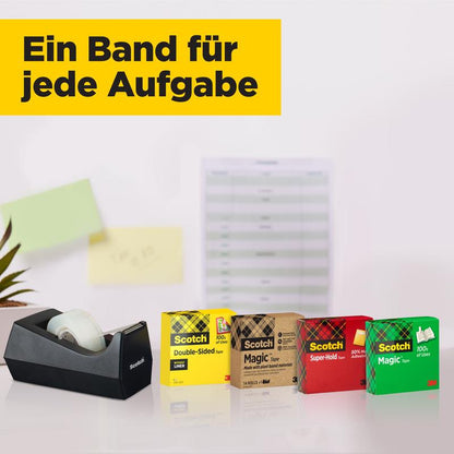A black tape dispenser stands next to a value pack with 14 rolls of Scotch® Magic™ Invisible Tape (19 mm x 33 m) from 3M Deutschland GmbH in colorful boxes. Blurred in the background: a paper board and green sticky notes.