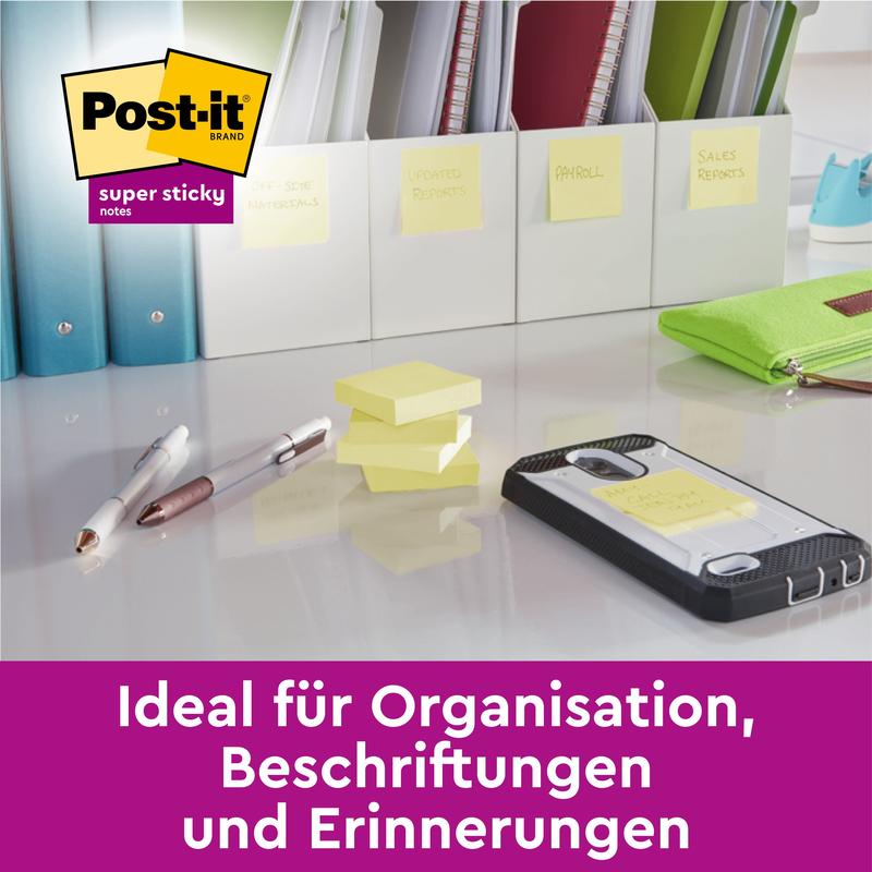 A desk with pens, sticky notes, a phone, and labeled folders. The Post-it® Super Sticky 100% Recycled Notes (47.6 x 47.6 mm, 70 sheets/block, 100% PEFC) from 3M Deutschland GmbH-ideal for organization and reminders.